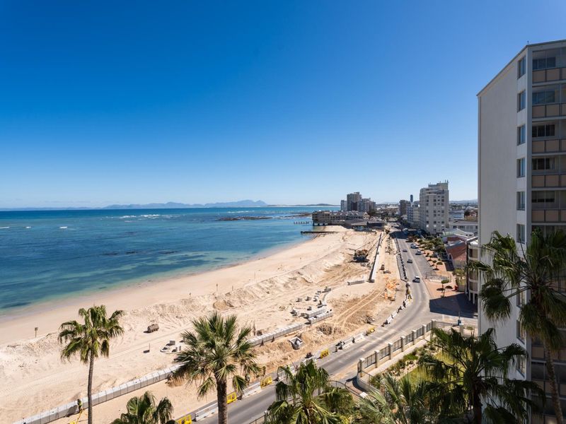 Elevated coastal view overlooking the beach, ocean, and surrounding urban coastline.