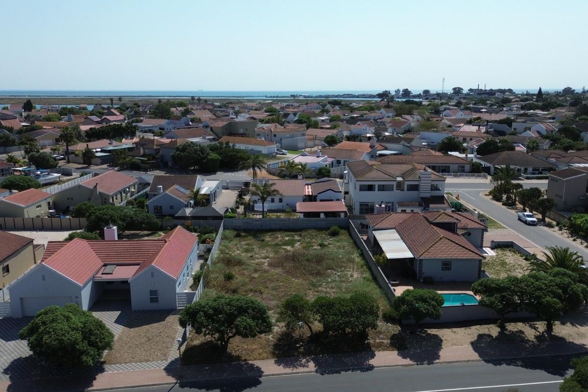 Aerial view of a vacant residential plot situated in a developed suburban neighborhood, offering potential for new construction.