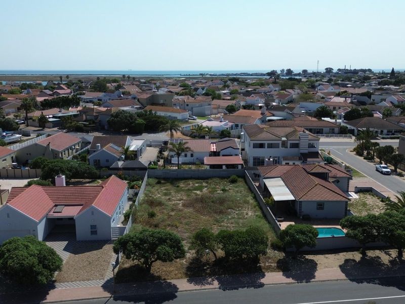 Aerial view of a vacant residential plot situated in a developed suburban neighborhood, offering potential for new construction.