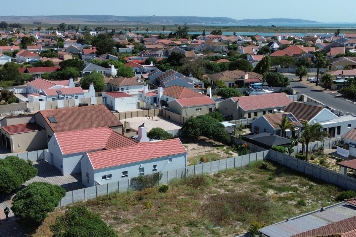 Aerial view of a vacant residential plot situated within an established suburban neighborhood, offering potential for new development.