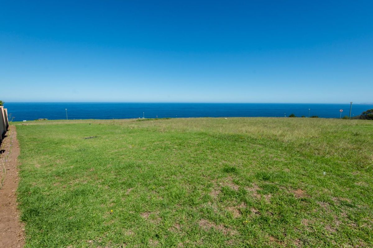 A vacant residential plot featuring expansive, unobstructed ocean views, offering a prime location for a custom home build.