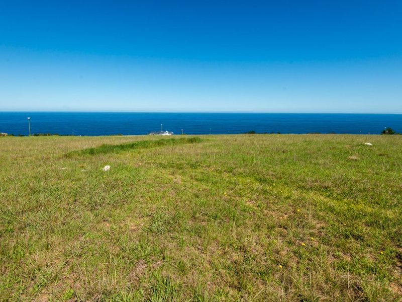 A wide-angle view of the ocean from a vacant residential plot, showcasing the expansive coastal landscape and horizon.
