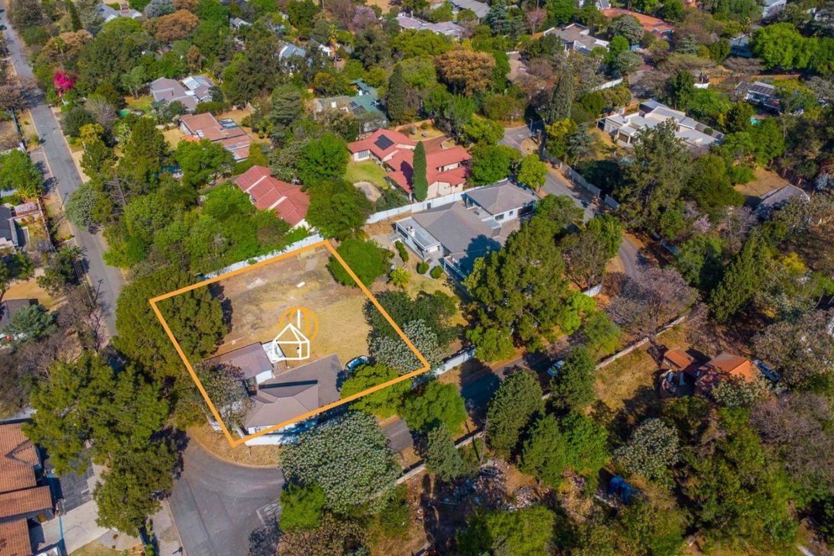 Aerial view of a residential vacant land plot situated in a well-established, tree-lined suburban neighborhood.