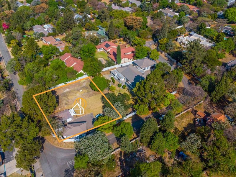 Aerial view of a residential vacant land plot situated in a well-established, tree-lined suburban neighborhood.