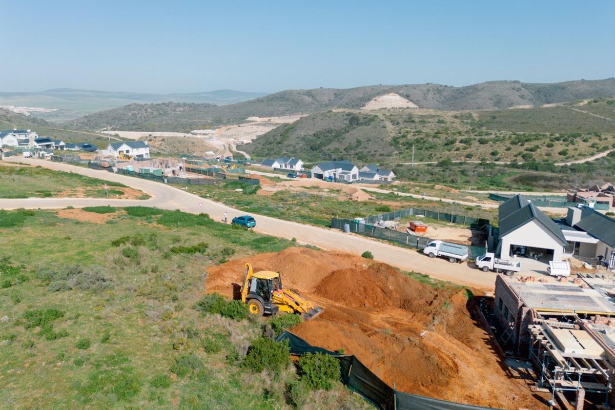 Aerial view of a residential development site showing ongoing excavation work and surrounding landscape in a developing estate.