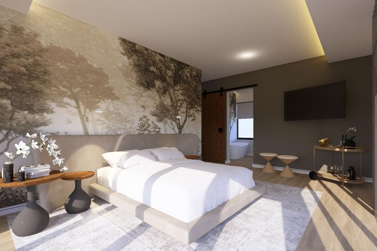 Modern bedroom featuring a feature wall, recessed ceiling lighting, and a sliding barn door leading to an en-suite bathroom.