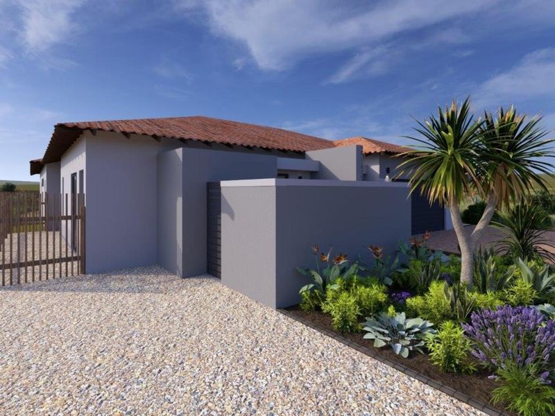 A modern residential exterior featuring a clean grey facade, terracotta roof tiles, a gravel driveway, and landscaped garden beds.