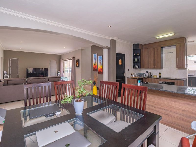 Spacious open-plan living area featuring a modern kitchen with granite countertops, built-in appliances, and seamless flow into the dining and lounge spaces.