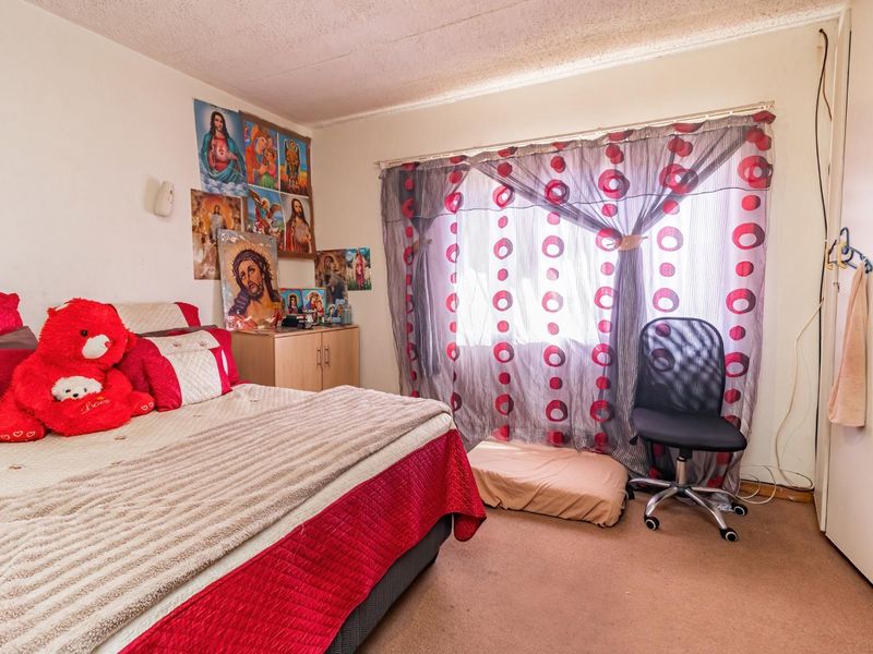 A bedroom featuring carpeted flooring and a built-in cupboard, requiring cosmetic updates to improve the overall condition and appeal.