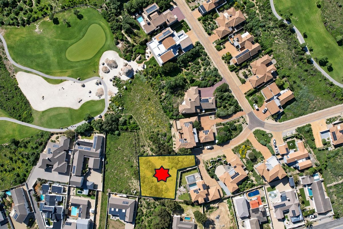 Aerial view of a vacant residential land plot situated within a developed estate, adjacent to golf course landscaping and existing residential properties.