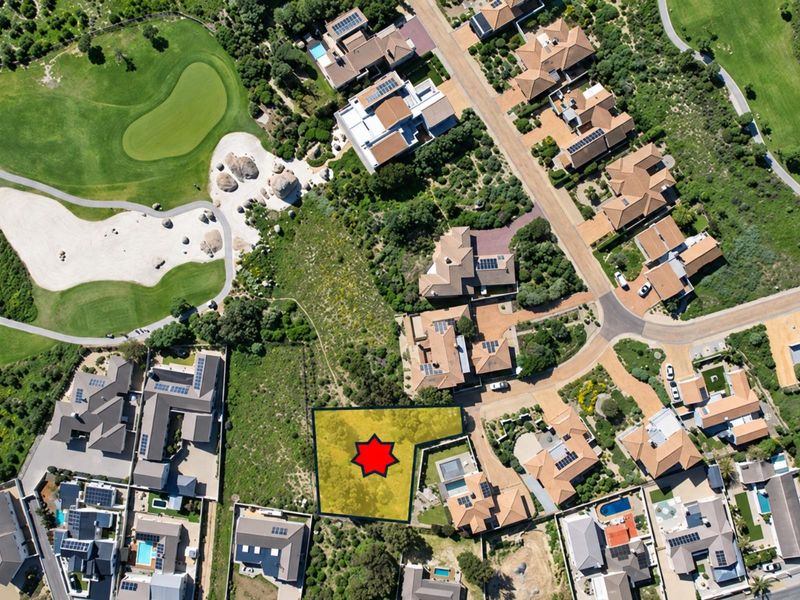 Aerial view of a vacant residential land plot situated within a developed estate, adjacent to golf course landscaping and existing residential properties.