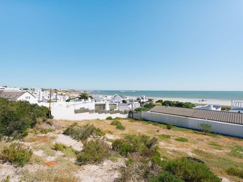 A scenic view overlooking the coastal landscape and ocean, showcasing the surrounding residential area and natural terrain.