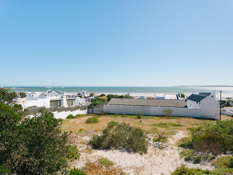 A scenic view overlooking the coastal landscape and surrounding residential properties from the vacant land plot.