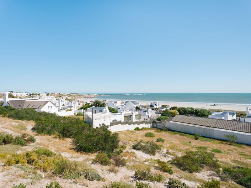 A scenic elevated view overlooking a coastal residential area and the ocean.