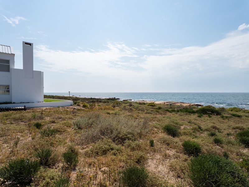 A scenic view of the coastal landscape and ocean frontage adjacent to the residential property.
