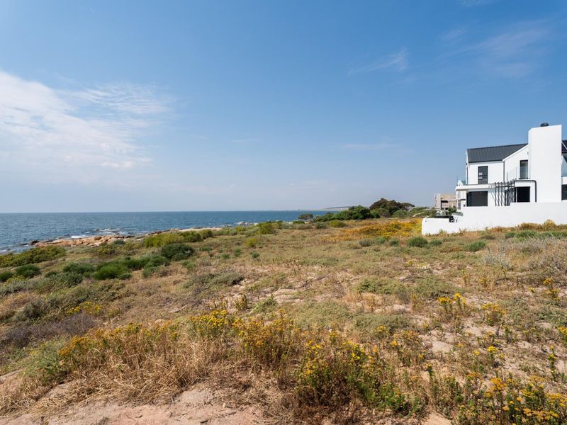 A scenic view of the coastal landscape and ocean, showcasing the natural beauty and prime location of the vacant residential land.