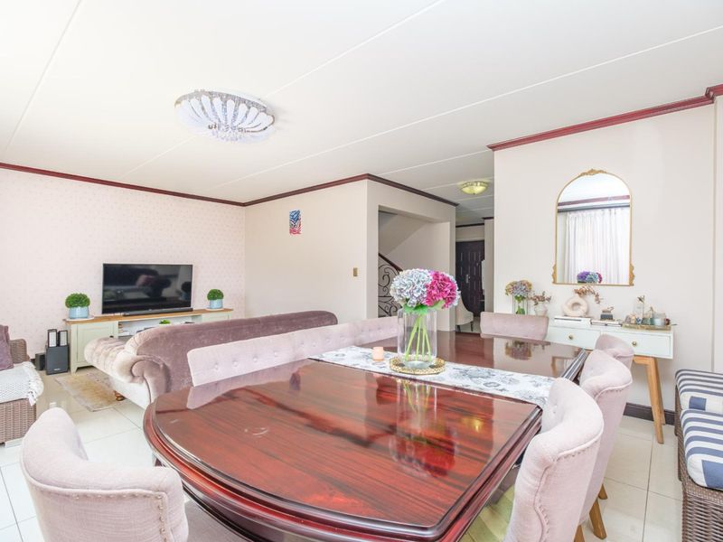 Spacious open-plan living and dining area featuring tiled flooring and neutral wall finishes, providing a versatile layout for family living and entertaining.