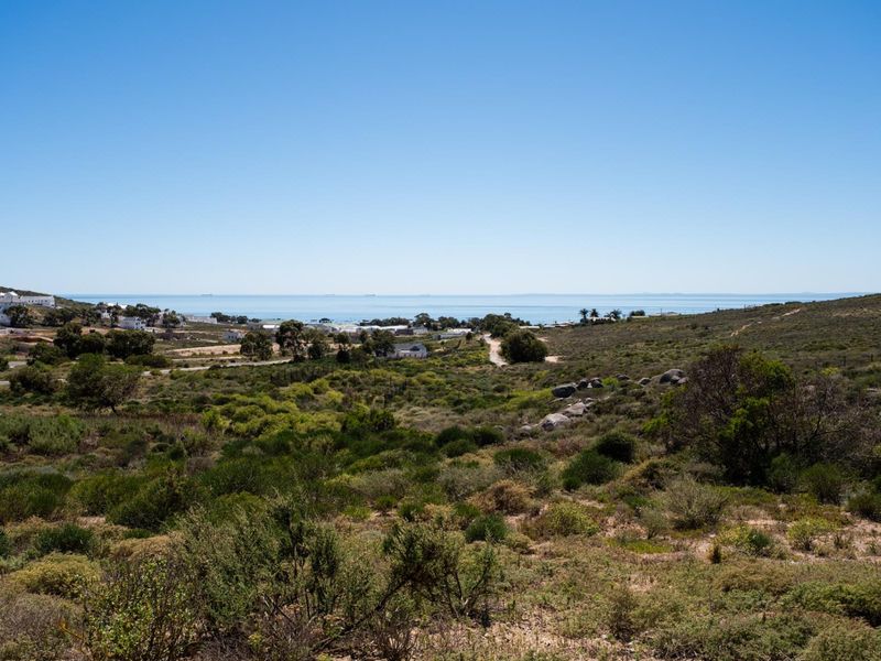 A scenic elevated view of the coastal landscape and surrounding natural vegetation, showcasing the property's expansive outlook.
