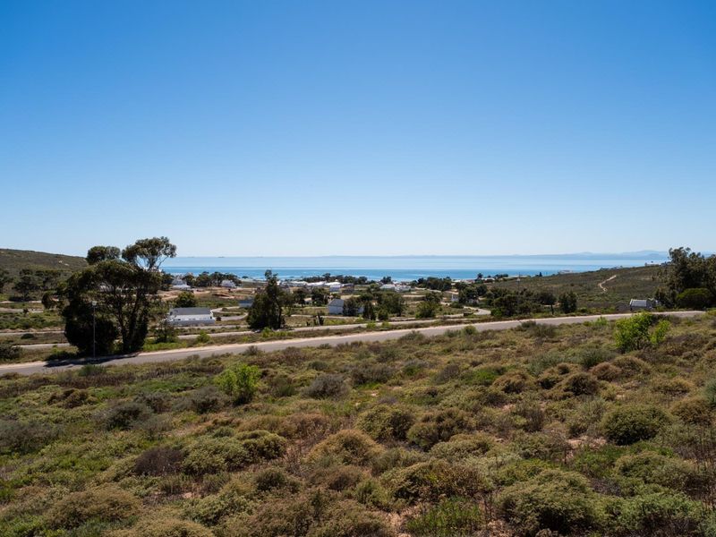 A scenic elevated view overlooking the surrounding coastal landscape, natural vegetation, and distant ocean horizon.