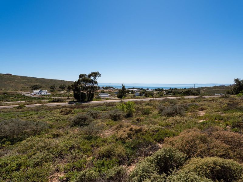 A scenic view of the coastal landscape and surrounding natural vegetation, showcasing the open terrain and distant ocean horizon.