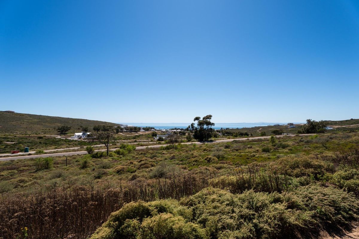 A scenic view of the coastal landscape and surrounding natural vegetation, showcasing the open terrain and distant ocean horizon.