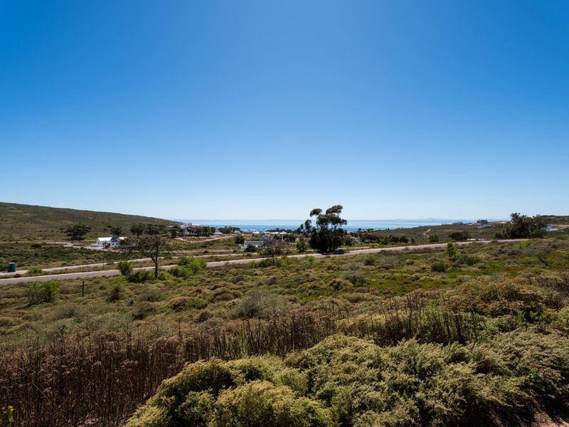 A scenic view of the coastal landscape and surrounding natural vegetation, showcasing the open terrain and distant ocean horizon.