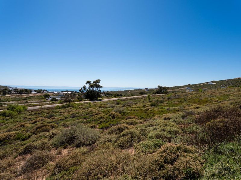A scenic view of the coastal landscape and surrounding natural terrain, showcasing the expansive outlook from the vacant residential land.