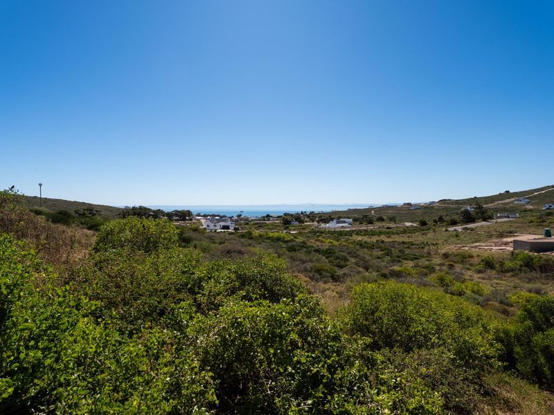A scenic elevated view overlooking the surrounding coastal landscape and natural vegetation, showcasing the property's expansive outlook.