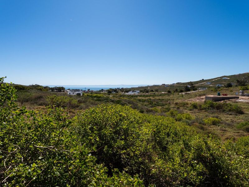 A scenic view overlooking the natural coastal landscape and surrounding residential area.