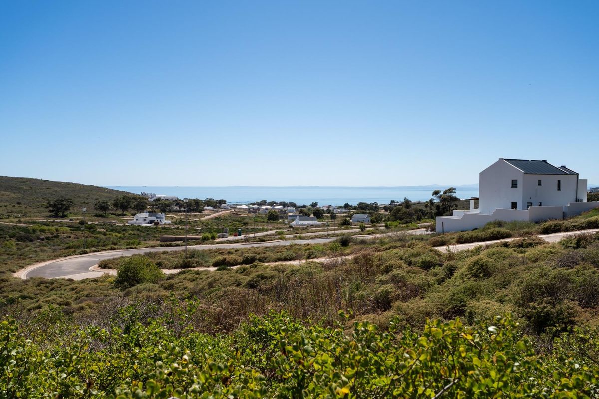 A scenic elevated view overlooking the coastal landscape, surrounding residential development, and distant ocean horizon.