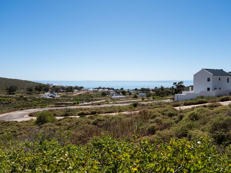 A scenic elevated view overlooking the coastal landscape, surrounding residential development, and distant ocean horizon.