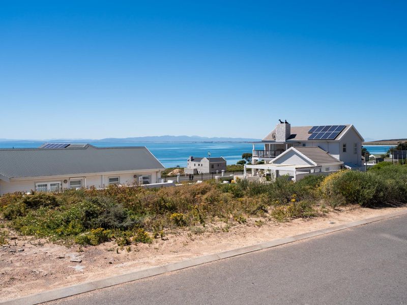 A scenic view overlooking the coastal landscape and ocean, showcasing the surrounding residential area and natural horizon.