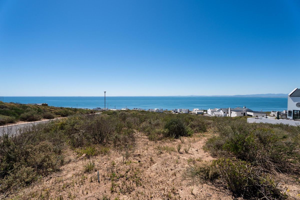 A scenic view of the ocean and coastal landscape from the vacant residential land plot.