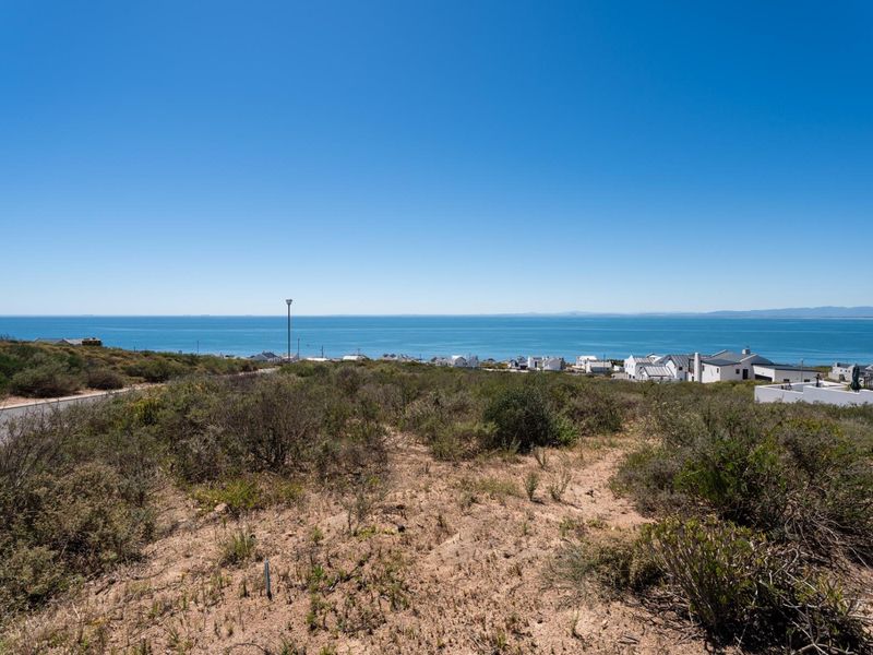 A scenic view of the ocean and coastal landscape from the vacant residential land plot.