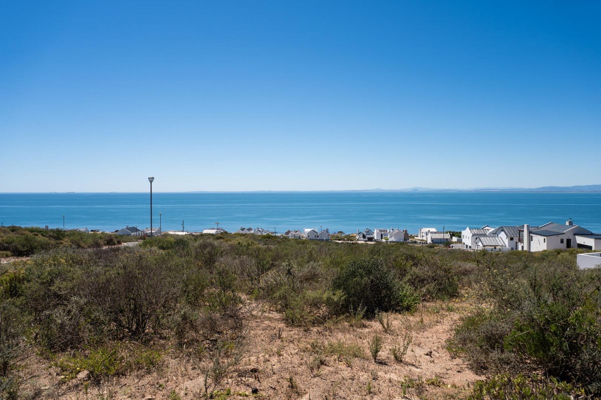 A scenic view of the ocean and coastal residential area from the vacant land plot.