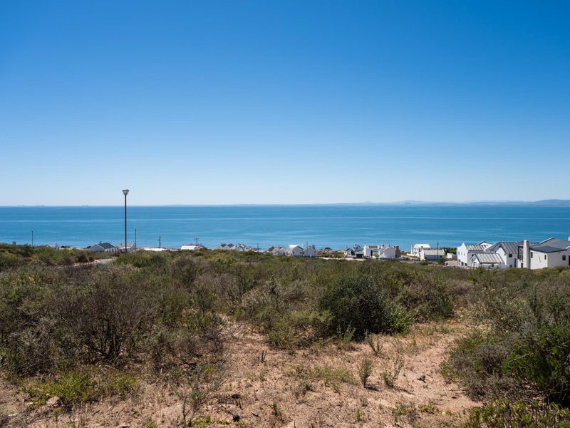 A scenic view of the ocean and coastal residential area from the vacant land plot.