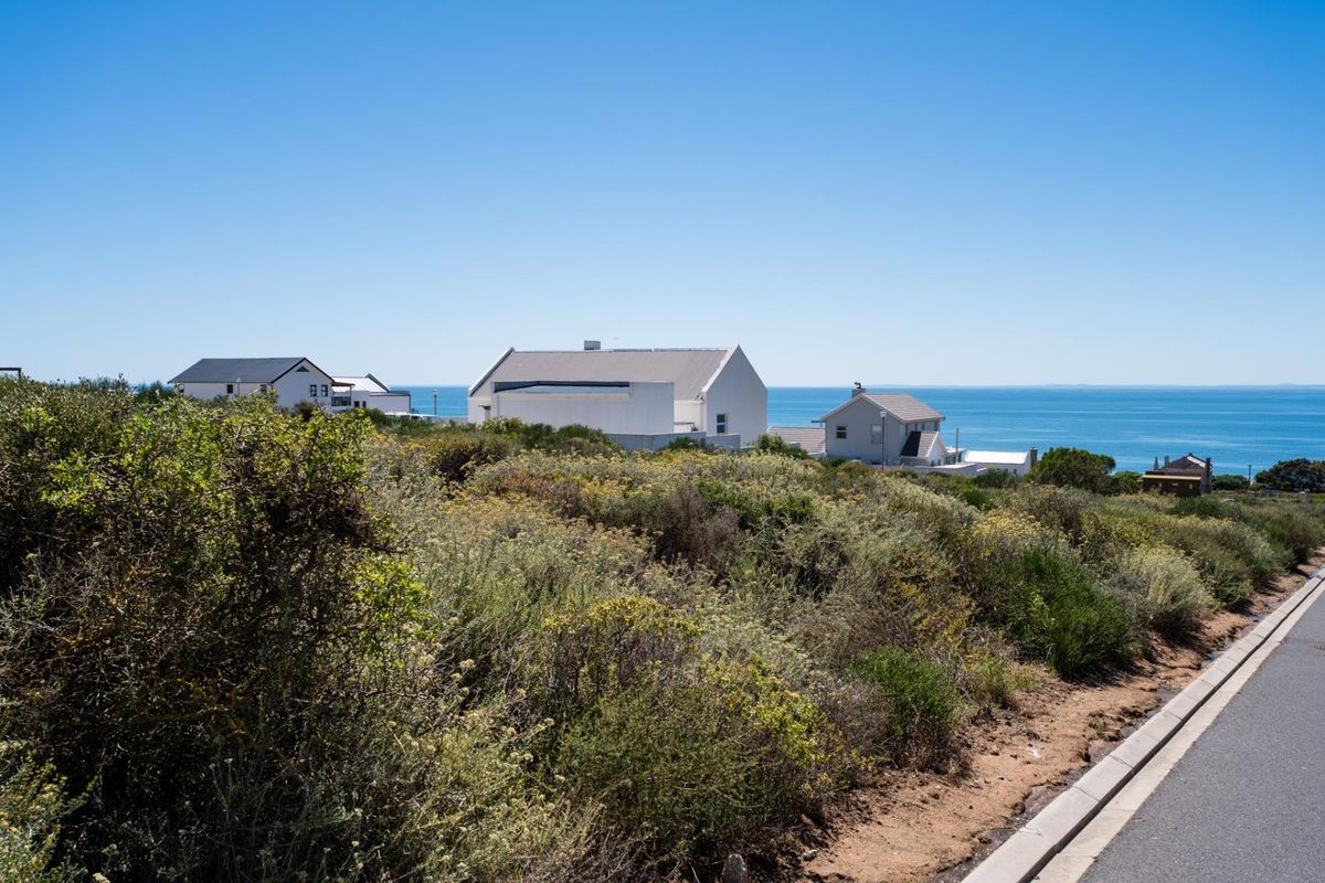 A scenic view of the coastal landscape and neighboring residential properties from the vacant land plot.