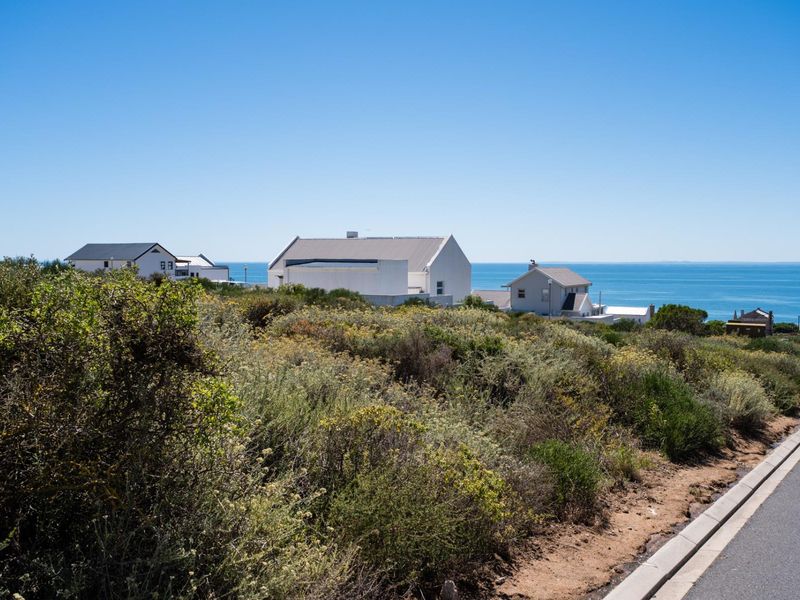 A scenic view of the coastal landscape and neighboring residential properties from the vacant land plot.