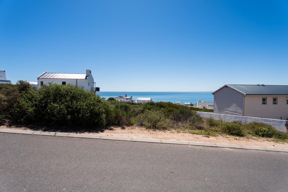 A clear view of the ocean and coastal landscape from the street level of the vacant residential property.
