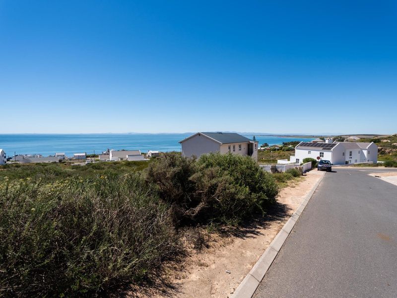 A scenic view of the coastal landscape and surrounding residential neighborhood from the street level.