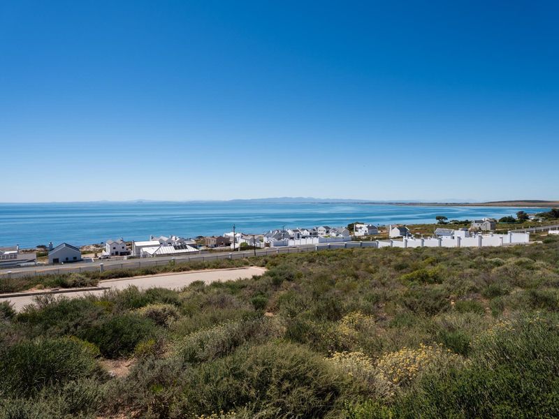 An elevated view overlooking the coastal landscape, ocean, and surrounding residential neighborhood.