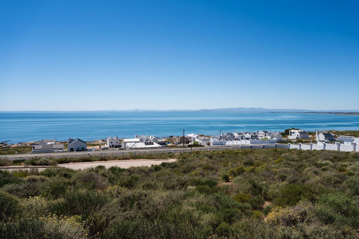 A scenic elevated view overlooking the coastline, ocean, and surrounding residential neighborhood.