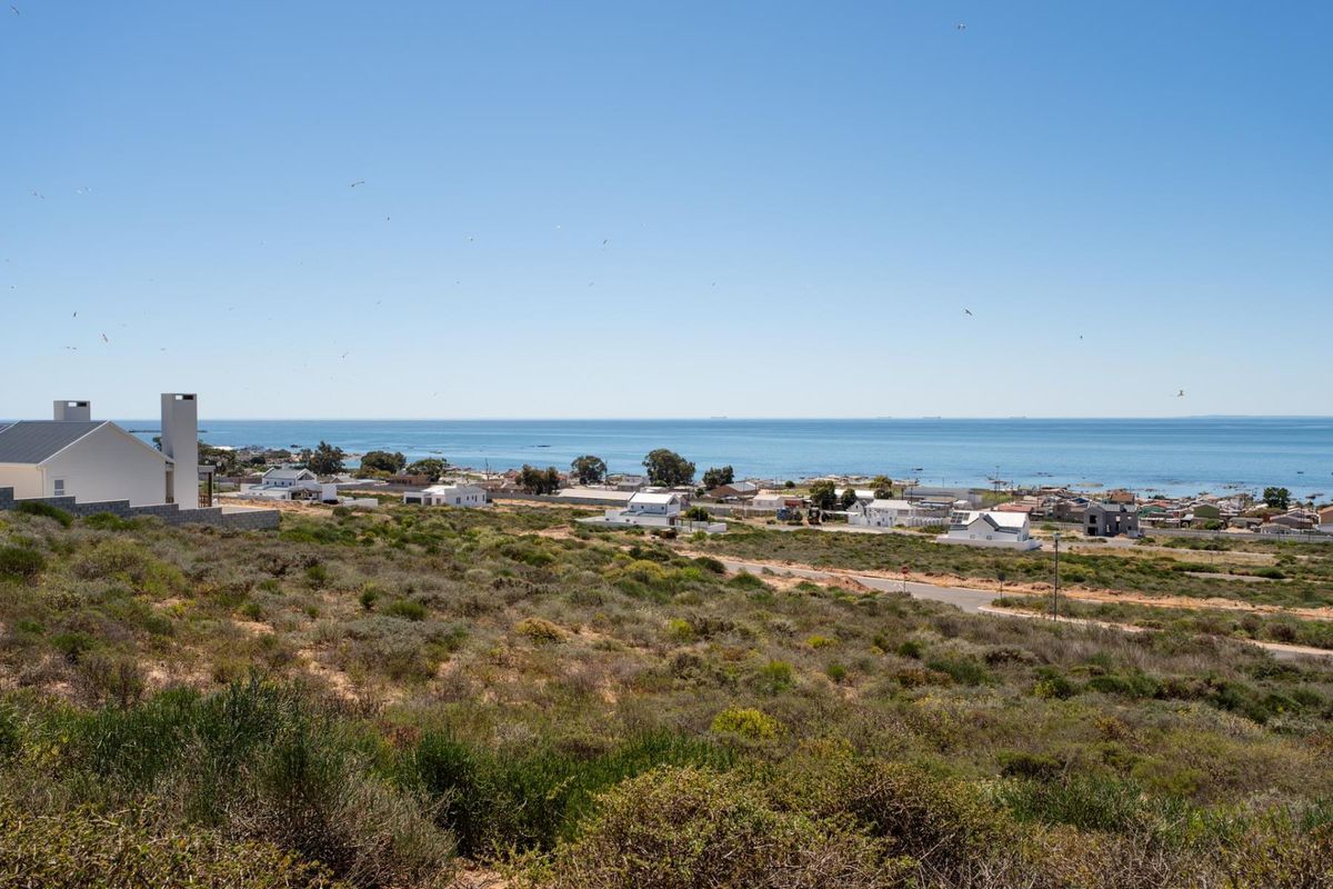 A scenic elevated view overlooking the coastal landscape, surrounding residential neighborhood, and the ocean horizon.