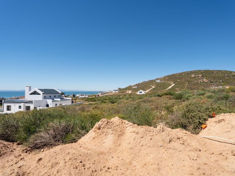 A scenic view overlooking the coastal landscape and surrounding residential development from the vacant land plot.