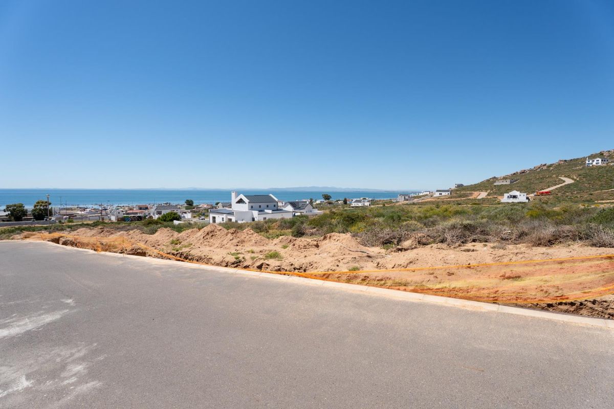 A view from a vacant residential plot overlooking the surrounding coastal landscape and neighborhood.