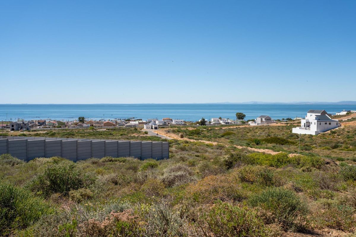 A scenic elevated view overlooking the coastal landscape, surrounding residential properties, and the ocean horizon.