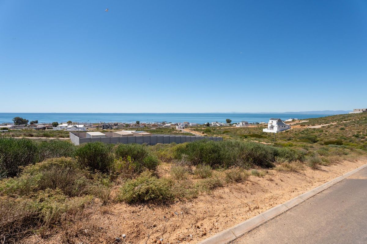 A scenic elevated view overlooking the coastal landscape and ocean, showcasing the surrounding neighborhood and natural terrain.