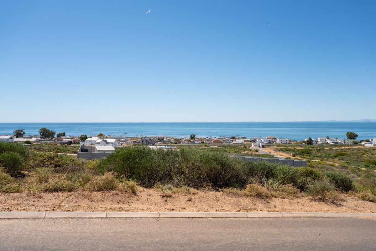 A clear, elevated view of the coastal landscape and ocean from the residential land plot.