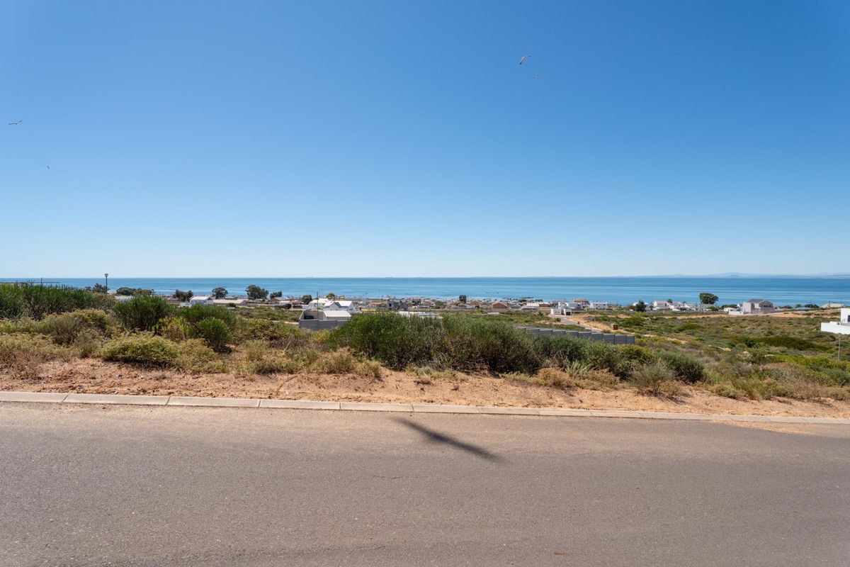 A scenic view overlooking the coastal landscape and ocean from the elevated residential plot.