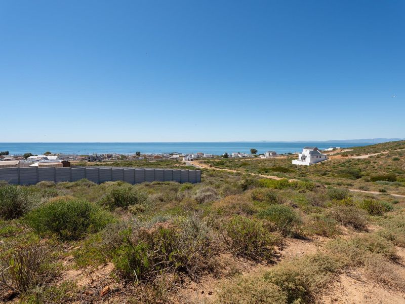 A scenic view overlooking the coastal landscape and ocean from the vacant residential land.